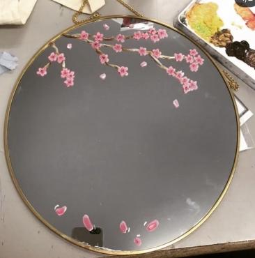 Cherry blossom mirror with a few petals on the bottom