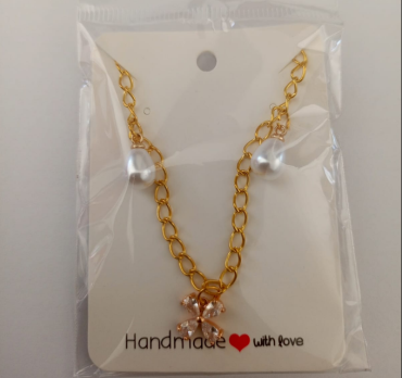 a necklace with pearls and a flower