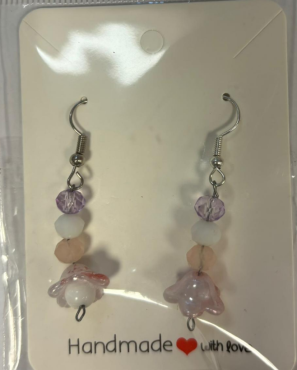A earring with silver hook with purple, white and pink bead with like a pink petal