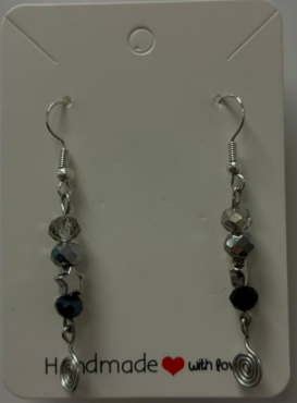 a silver hook earing with grey bead, black bead and a silver star with a darker black bead with a black metal spiral at the bottom