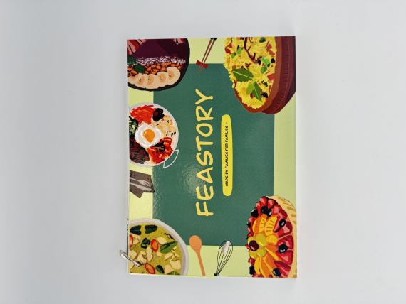 Picture of front of recipe card with the company name on the front “Feastory” with slogan underneath “from families for families”