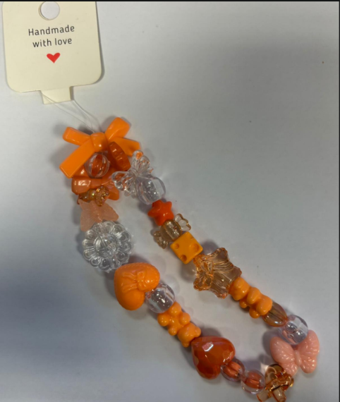 Bright orange phone charm.