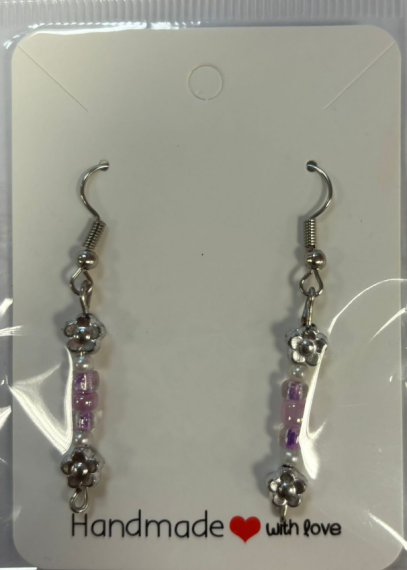 silver hook earrings with a silver, white and purple colour scheme and a silver flower