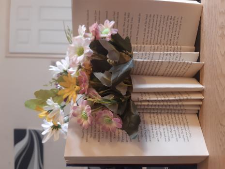 Beautiful pink, yellow and white spring flowers in a folded hard back book bouquet 