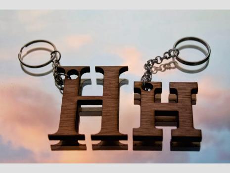 Two rustic keychains of varying size on a gorgeous sunset background. 