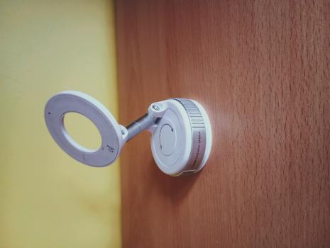 A white phone holder which is angled for a phone