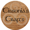 A wooden circle with a wooden triskelion and the text Cissonia's Crafts.
